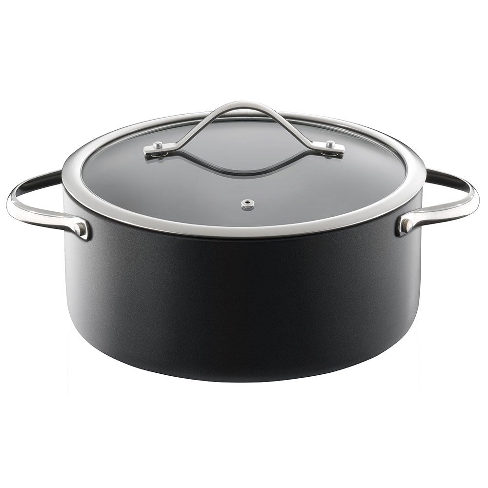 Top view of a black casserole with artichokes and potatoes on a table - Baccarat id3 Hard Anodised