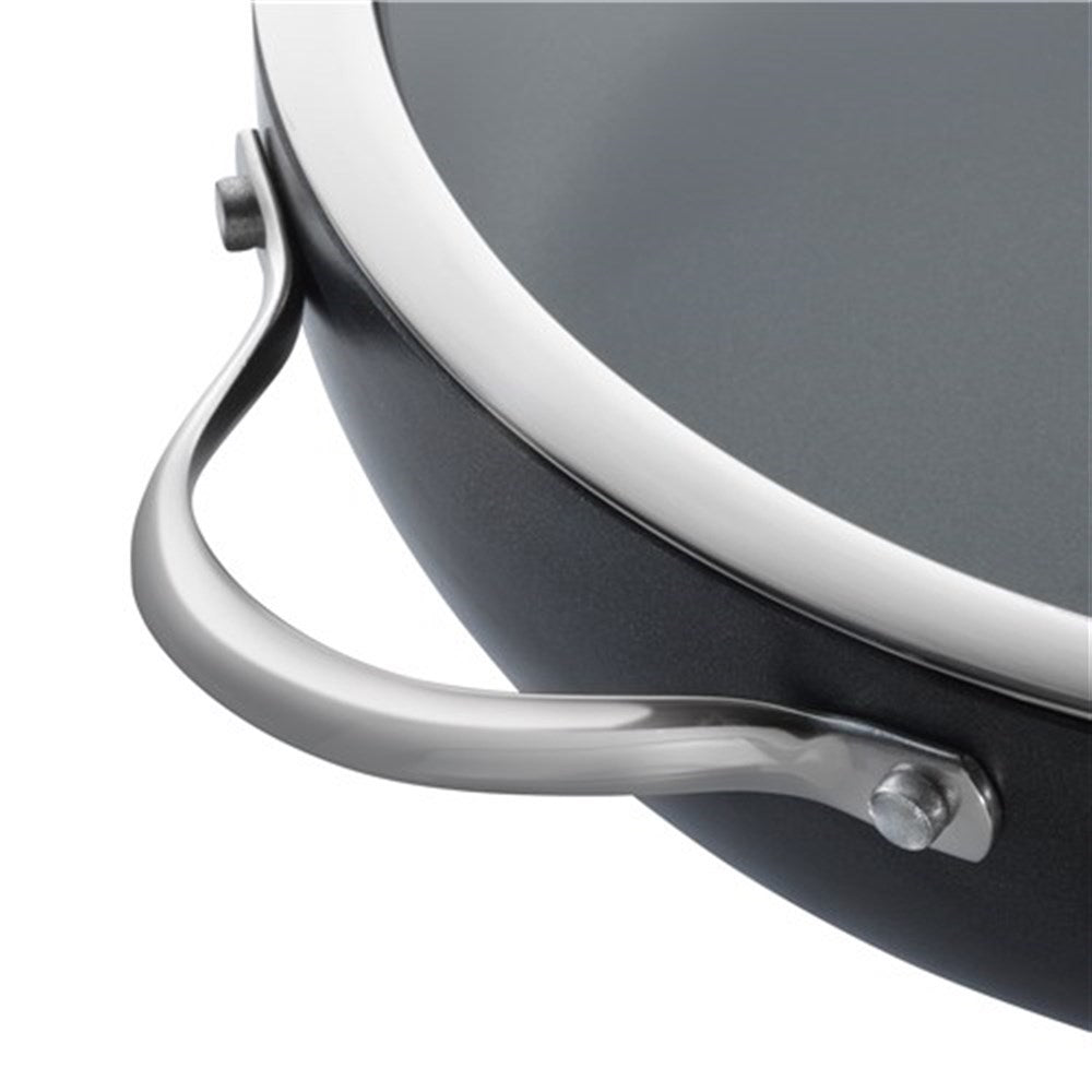 Top view of a black casserole with artichokes and potatoes on a table - Baccarat id3 Hard Anodised