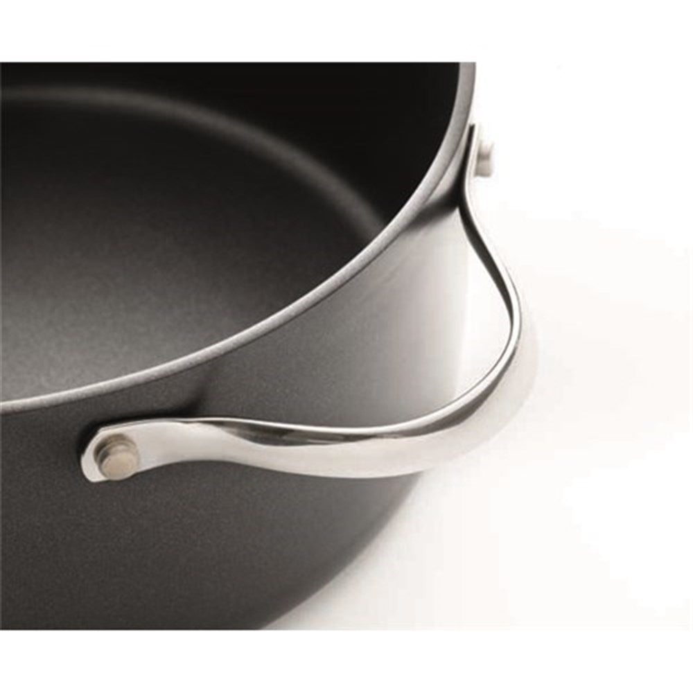 Top view of a black casserole with artichokes and potatoes on a table - Baccarat id3 Hard Anodised