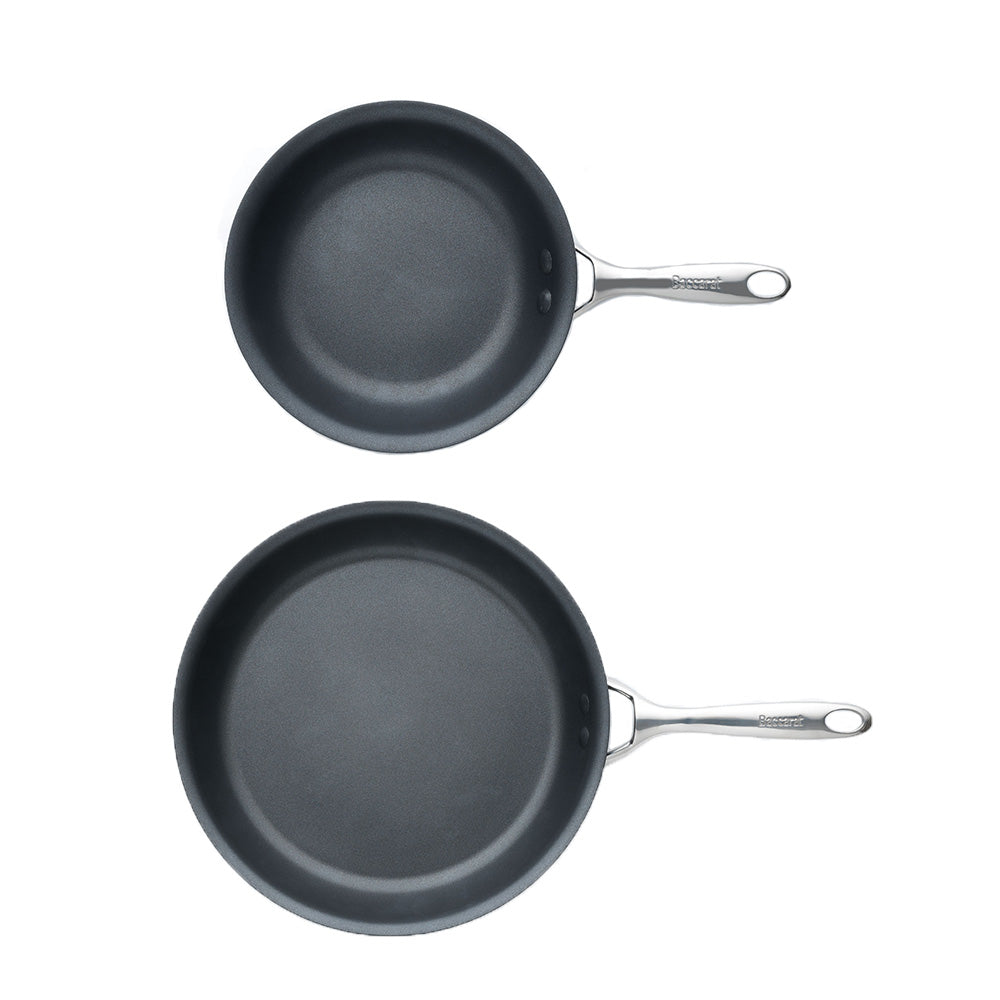Two frying pans with bell pepper slices on a gray surface - Baccarat id3 hard anodised frypan