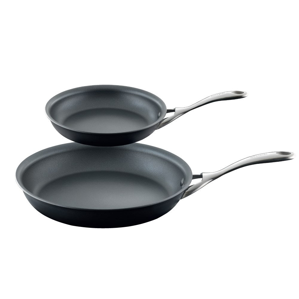 Two hard anodised non stick frying pans with vibrant tomatoes and peppers - Baccarat