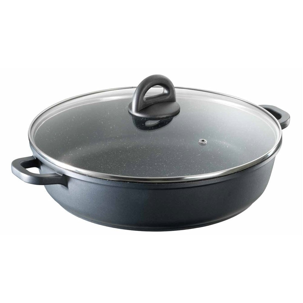 Overhead view of a frying pan filled with green beans and onions on a grey surface - Baccarat