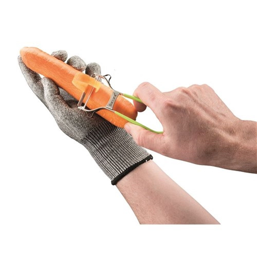 Grating cheese with a protective glove on a stainless steel grater with a sleek design - Baccarat