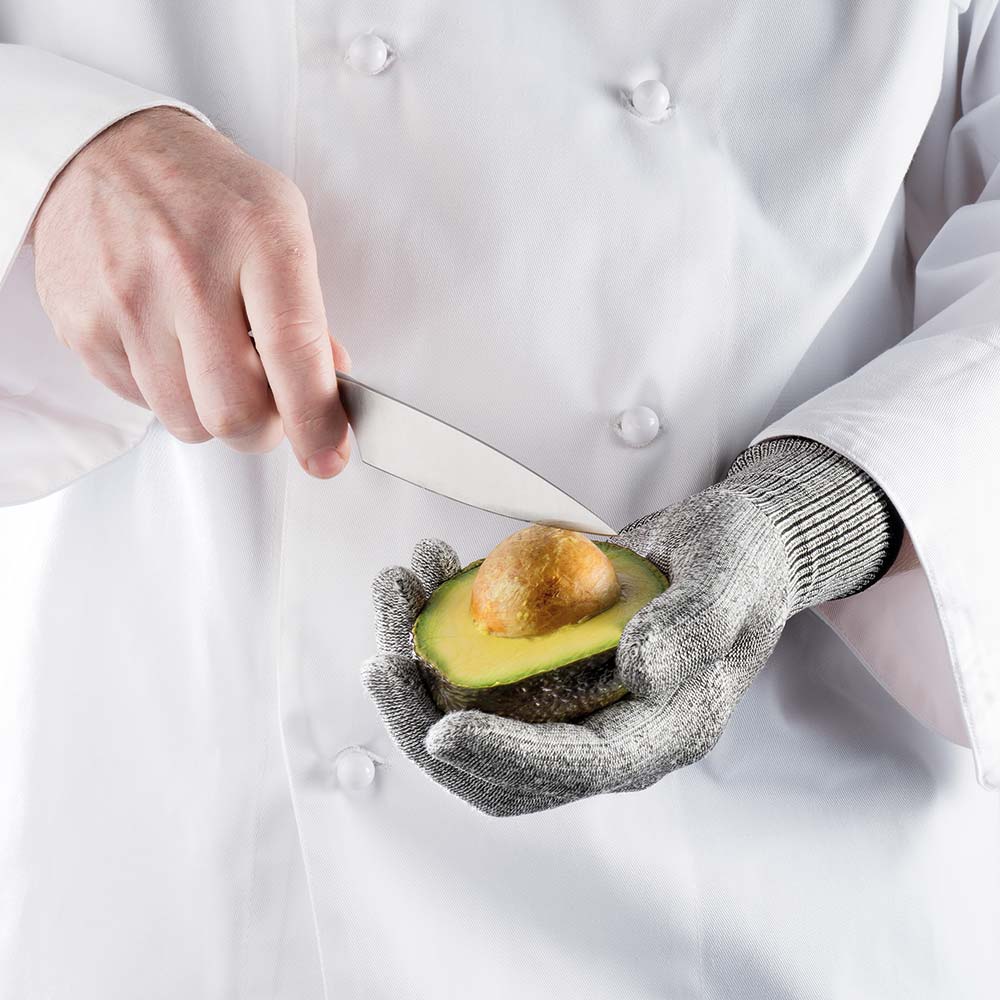 Grating cheese with a protective glove on a stainless steel grater with a sleek design - Baccarat