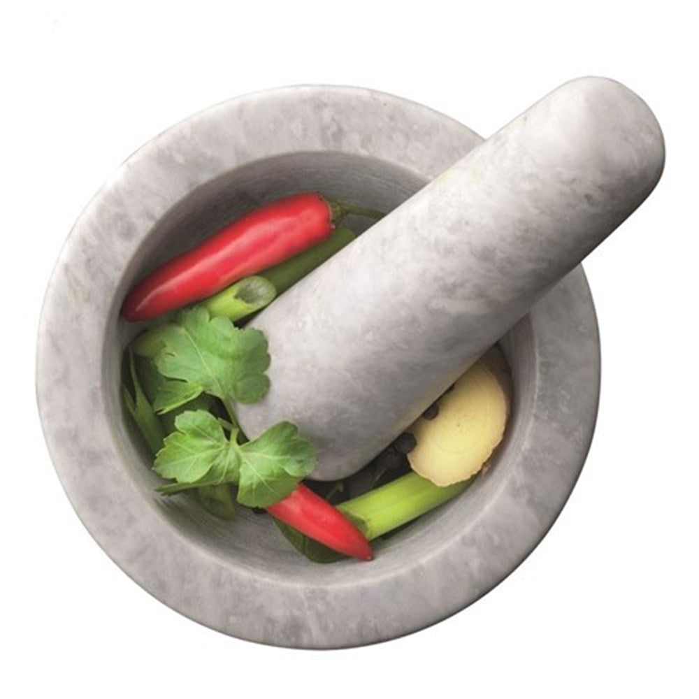 Rotary drum grater shredding fresh herbs and red chilies for cooking - Baccarat Prepare