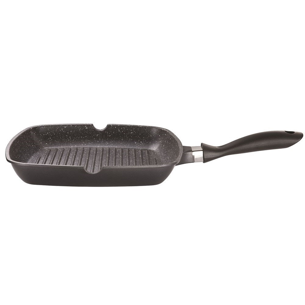 Person grilling corn with a black stone grill pan and spices nearby - Baccarat