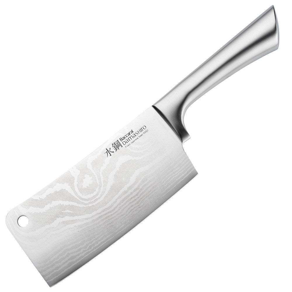 A Baccarat Damashiro cleaver with a sleek finish on a rustic surface surrounded by fresh ingredients