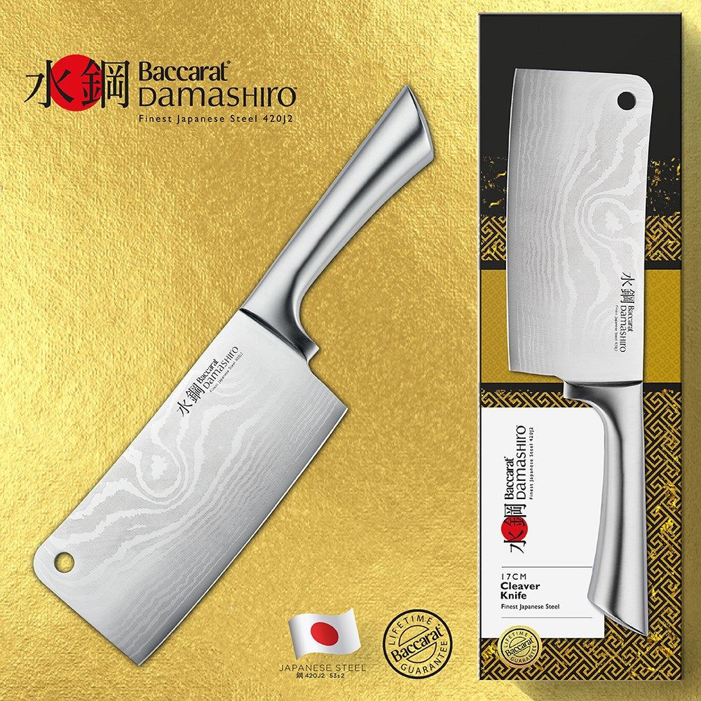 A Baccarat Damashiro cleaver with a sleek finish on a rustic surface surrounded by fresh ingredients