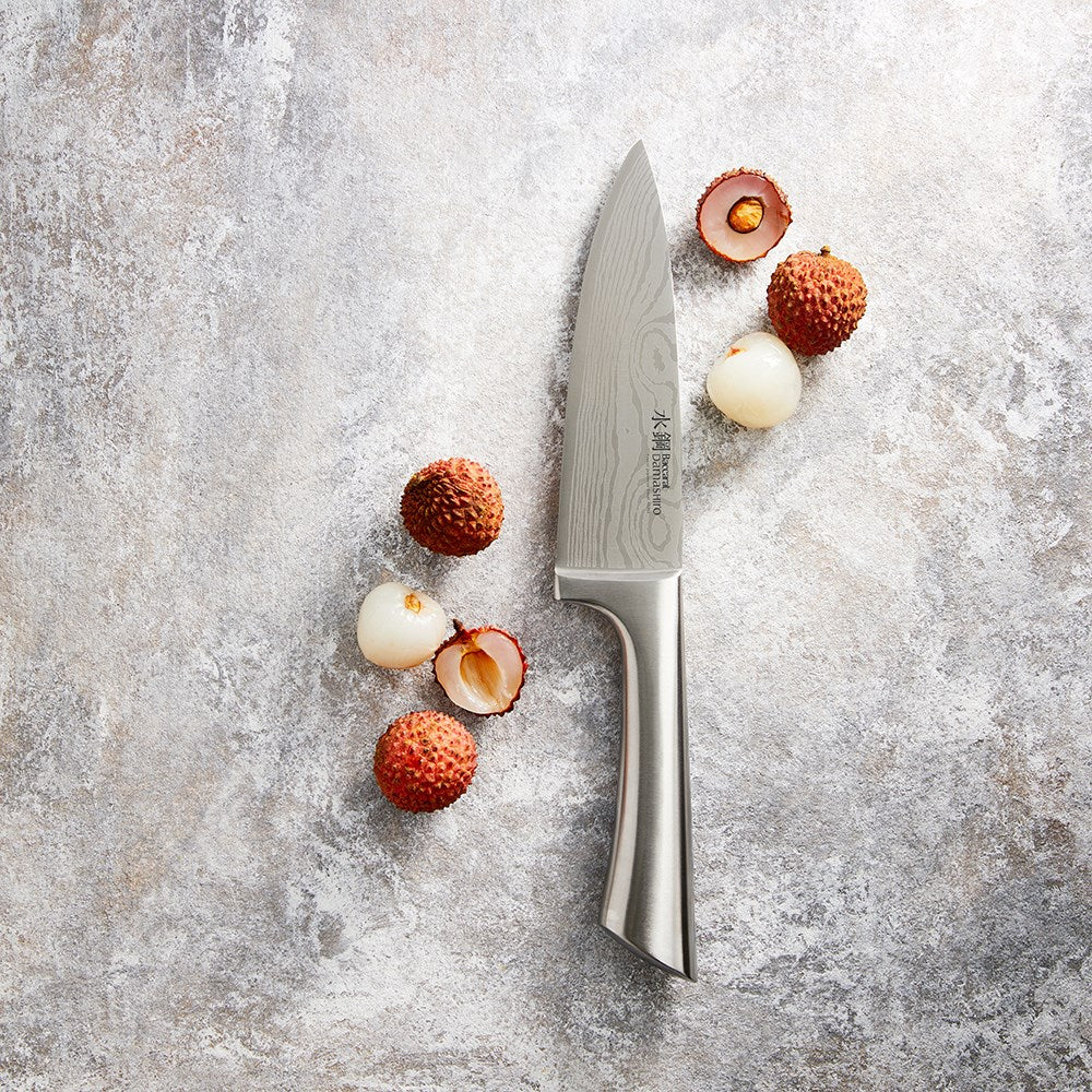 A Baccarat Damashiro Mini chef knife in a protective box with a polished blade and ergonomic handle