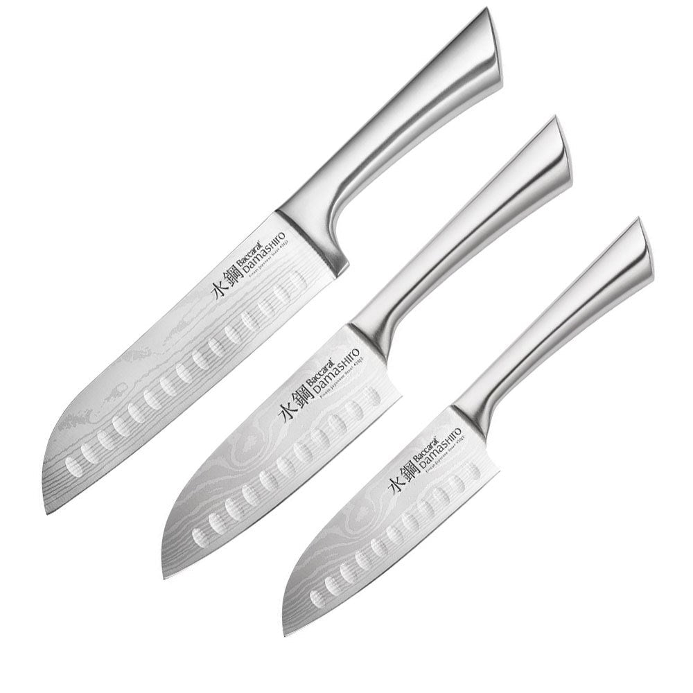 Three sleek santoku knives with textured blades on a gold and black background - Baccarat Damashiro