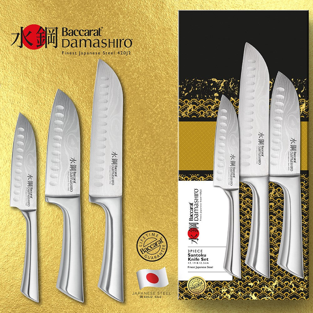 Three sleek santoku knives with textured blades on a gold and black background - Baccarat Damashiro