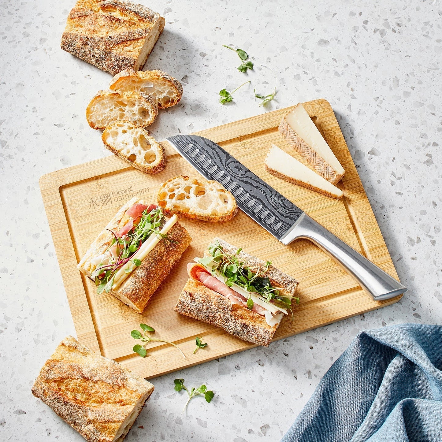 Sliced sandwich on a wooden board with a knife cheese and fresh ingredients - Baccarat damashiro