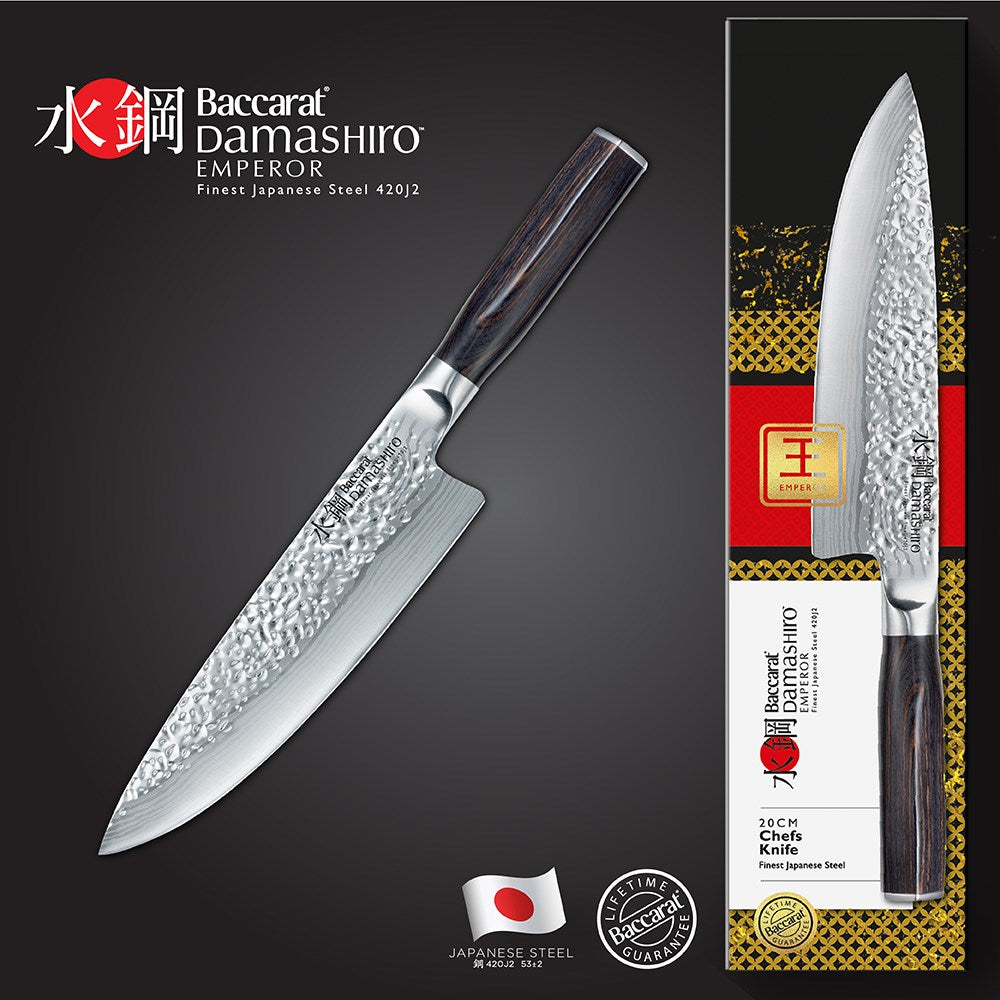Sliced red peppers on a stone board with a sharp knife - Baccarat damashiro emperor chefs knife 20cm