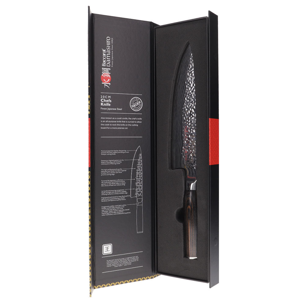 Sliced red peppers on a stone board with a sharp knife - Baccarat damashiro emperor chefs knife 20cm