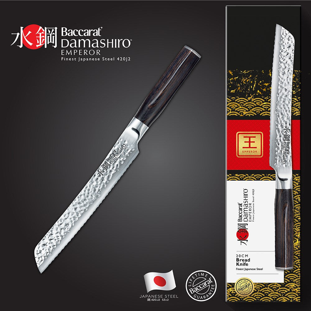 A Baccarat Emperor 20cm bread knife with a sharp edge on a wooden surface surrounded by other knives