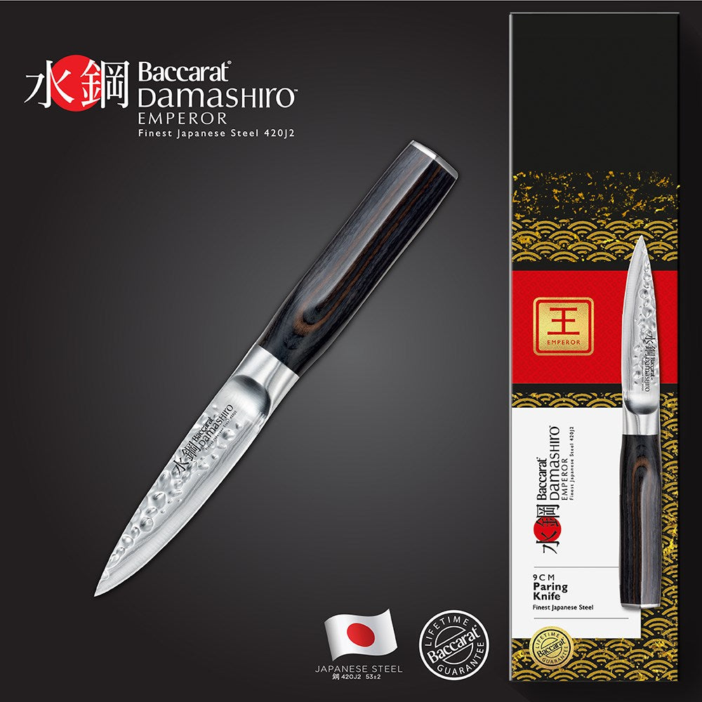 Chopped green herbs on a dark cutting board with a sleek silver knife - Baccarat Damashiro Emperor