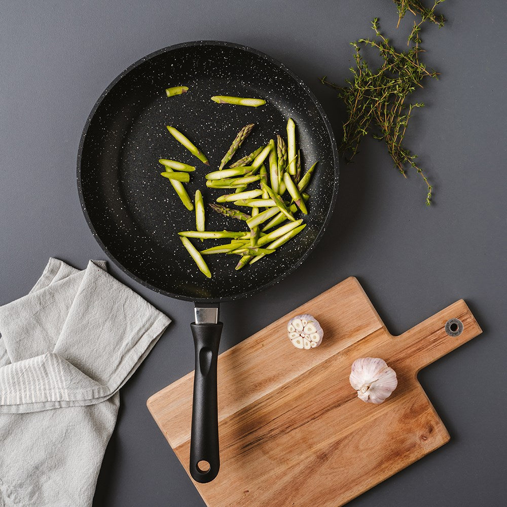 A durable non-stick frying pan with a speckled design ergonomic handle for easy cooking - Baccarat