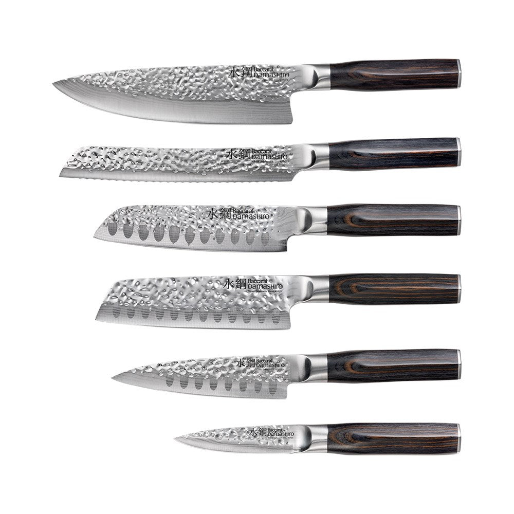 Seven sleek knives in a stylish wooden block on a countertop gleaming in light - Baccarat damashiro