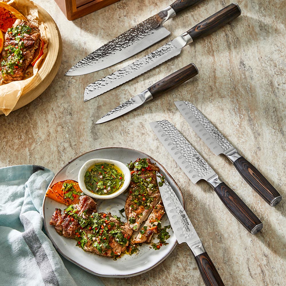 Seven sleek knives in a stylish wooden block on a countertop gleaming in light - Baccarat damashiro