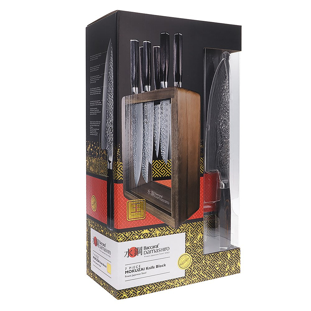 Seven sleek knives in a stylish wooden block on a countertop gleaming in light - Baccarat damashiro