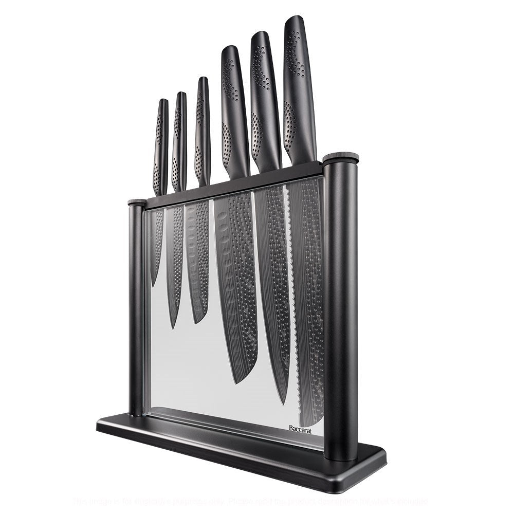 A person chops cabbage on a modern counter with a black knife block displaying knives - Baccarat