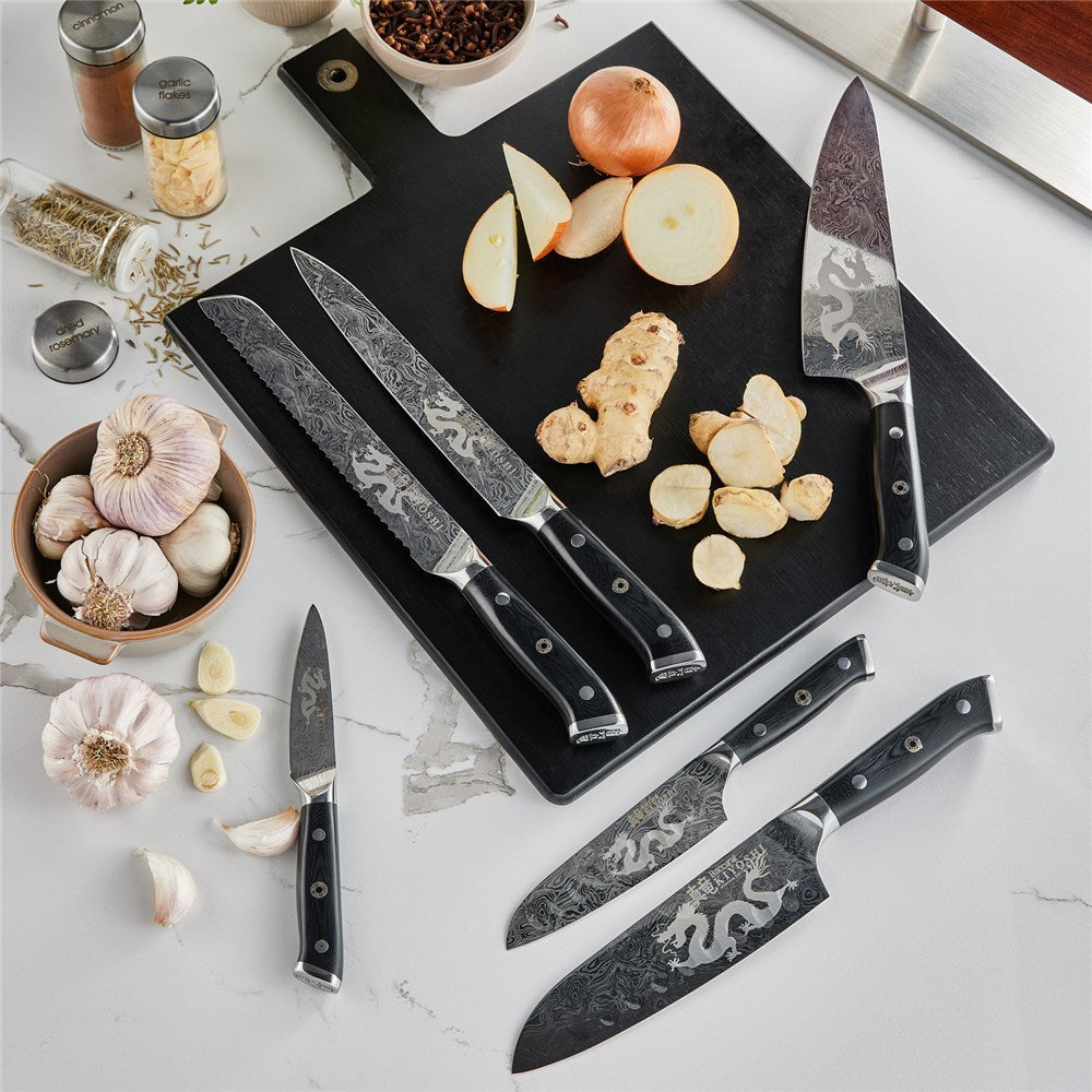 Person chopping ginger and garlic on black cutting board with black Samurai cleaver knife - Baccarat