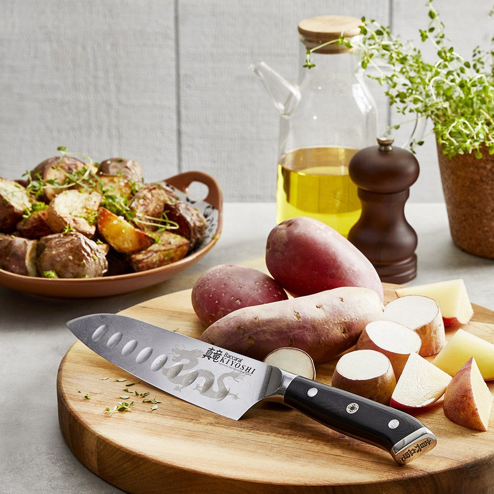 Sliced red potatoes on a wooden board with herbs and oil - Baccarat kiyoshi santoku knife 15cm