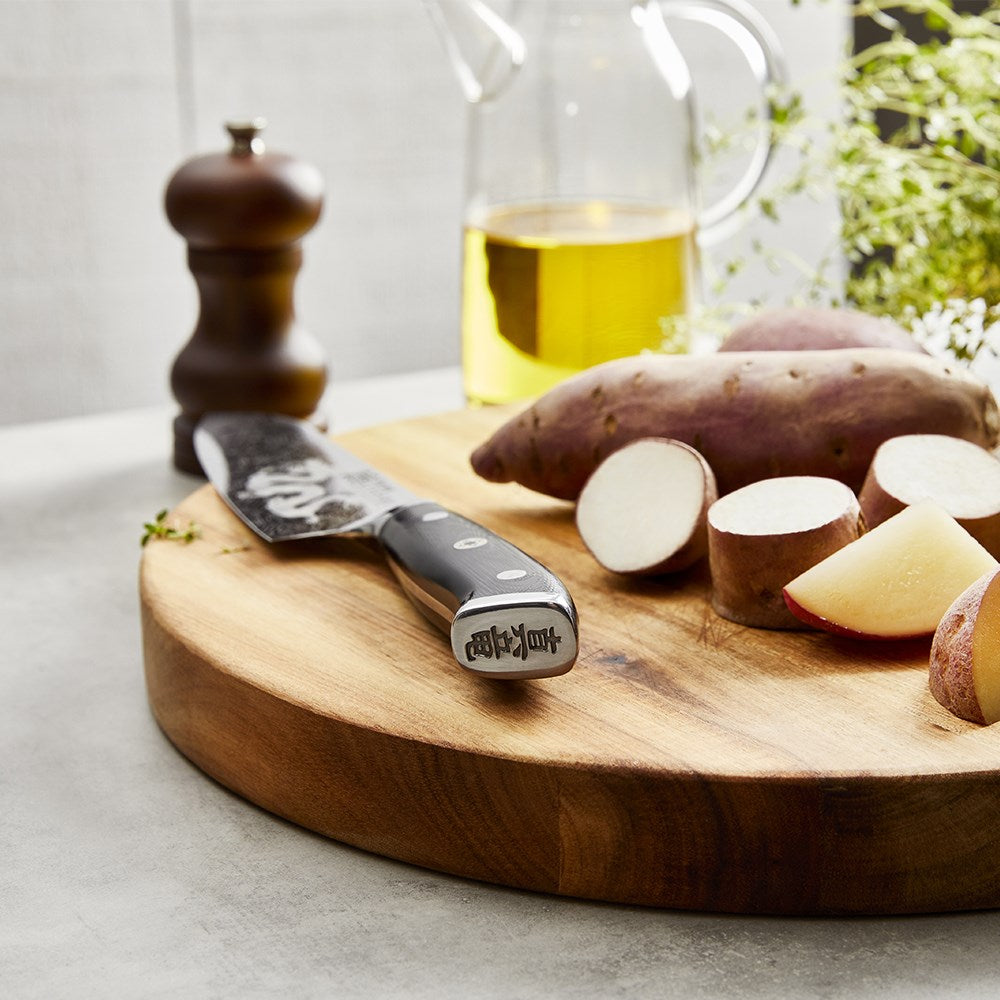 Sliced red potatoes on a wooden board with herbs and oil - Baccarat kiyoshi santoku knife 15cm