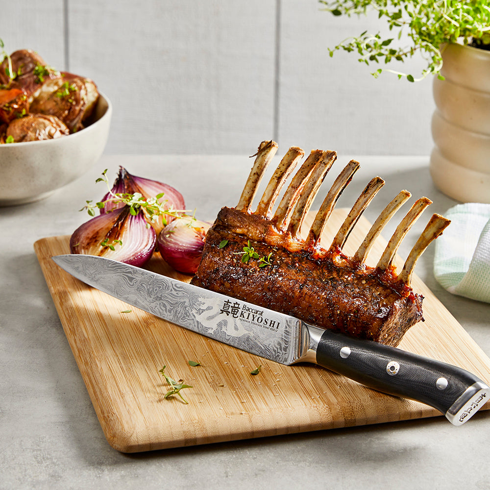 Sharp chefs knife on wooden board with lamb ribs and onions - Baccarat kiyoshi carving knife 20cm