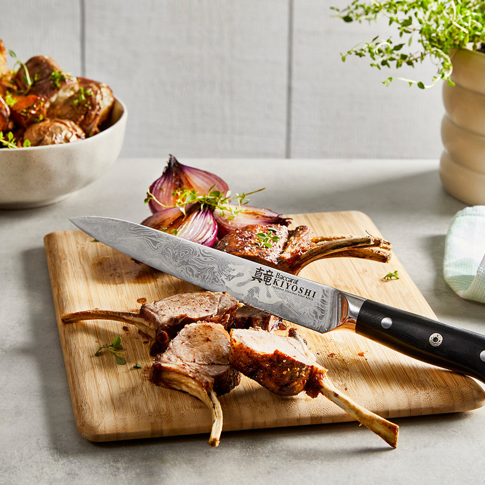 Sharp chefs knife on wooden board with lamb ribs and onions - Baccarat kiyoshi carving knife 20cm
