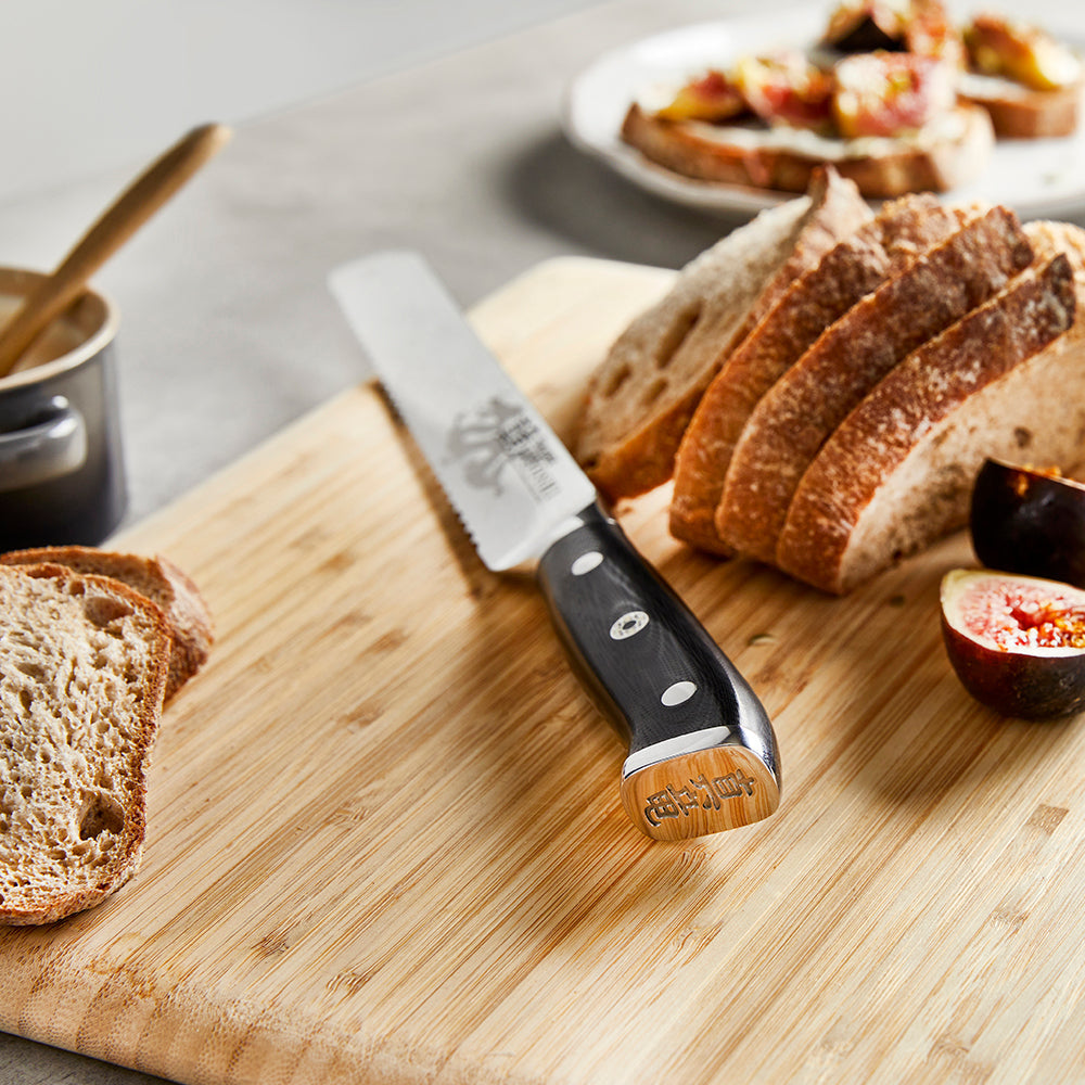 Sliced bread on cutting board with black knife, figs and spread - Baccarat Kiyoshi Bread Knife 20cm