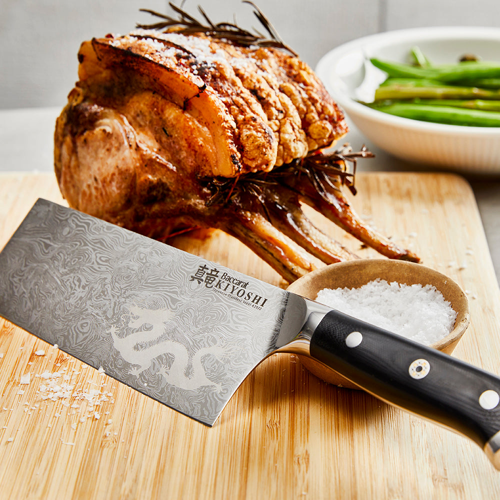 Sliced fresh bread on a wooden board with a sharp knife and vibrant vegetables - Baccarat Kiyoshi