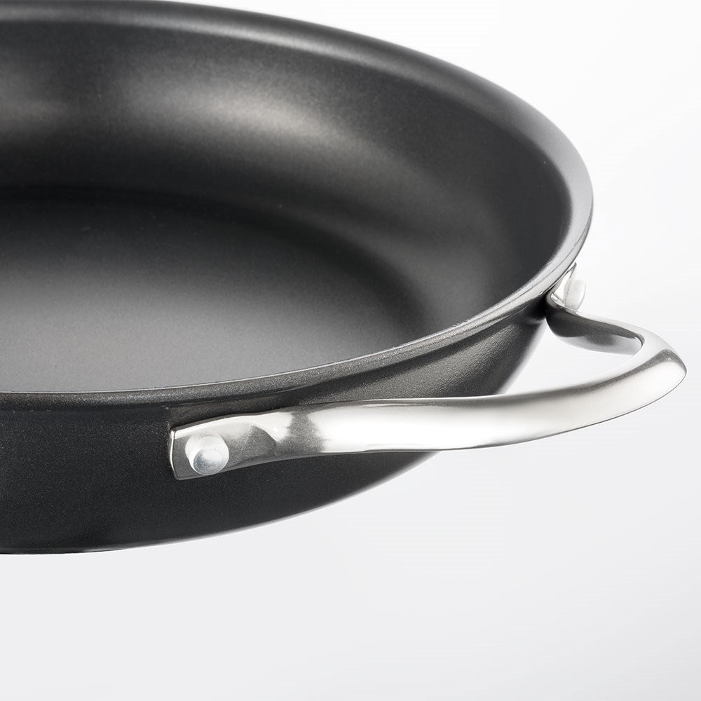 Aerial view of a frying pan filled with fresh green vegetables non-stick serving pan 24cm - Baccarat