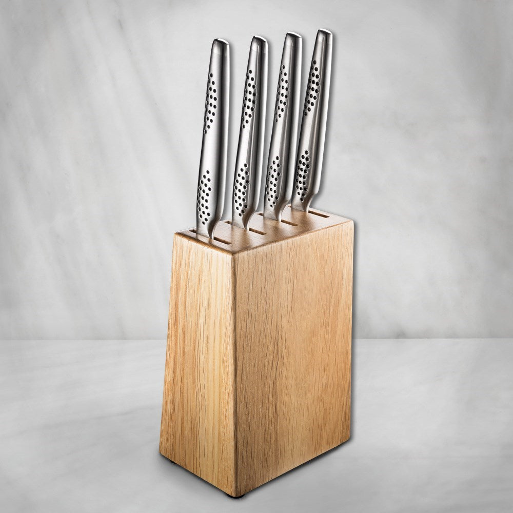 A wooden knife block holds five sleek stainless steel knives 20cm filleting knife - Baccarat