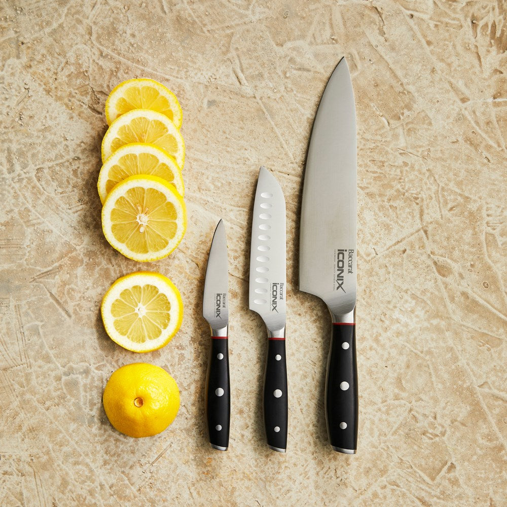 Three Baccarat stone milk pan with pourer 1l 16cm beside sliced lemons on a beige surface - Baccarat