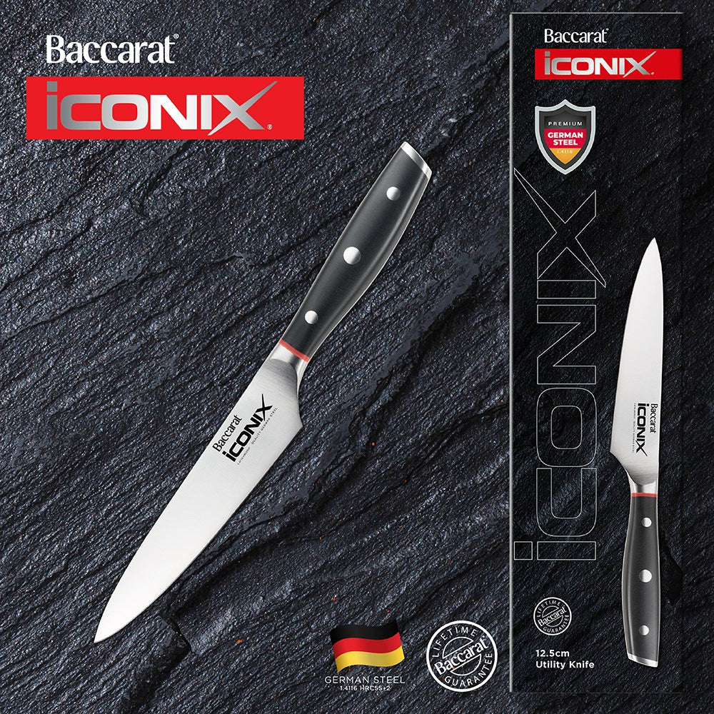 A sleek silver kitchen knife on a dark slate background black handle utility knife 12 5cm - Iconix