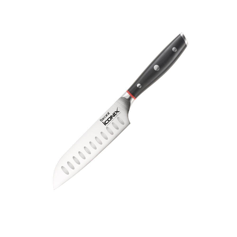 A sleek utility knife with a black handle beside sliced figs on a light surface - Baccarat Iconix