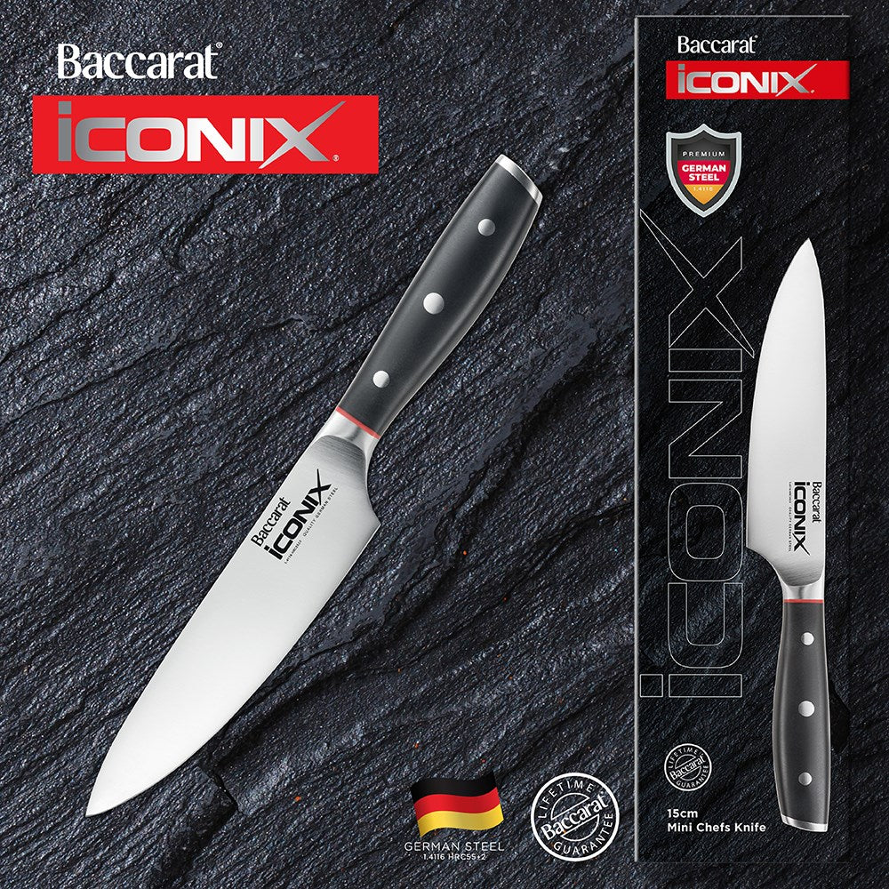 Black-handled chef's knife with red accents on a textured surface 15cm mini chef knife - Baccarat