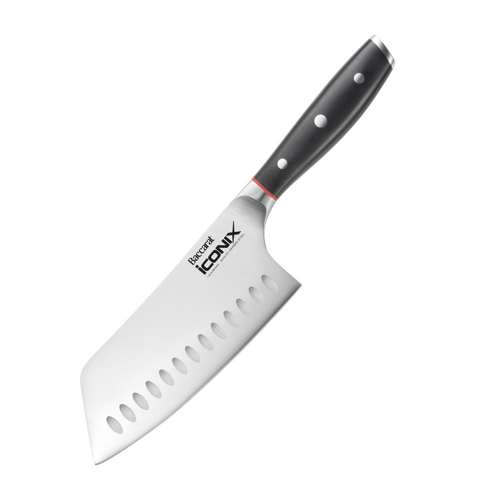 Chopped cauliflower on beige surface next to a silver cleaver knife with a black handle - Baccarat