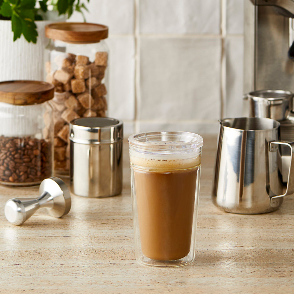 Double walled glass travell coffee cup with layered coffee and milk showcasing pattern - Baccarat