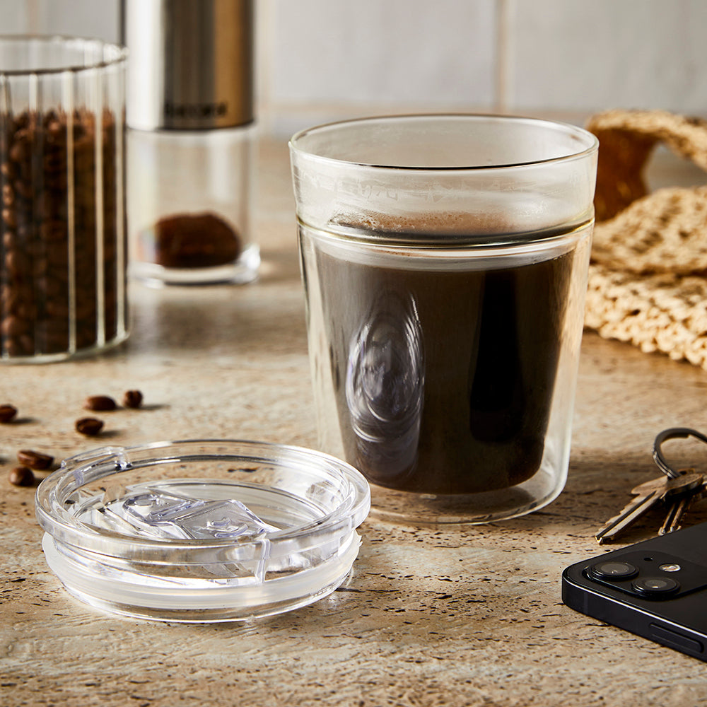 A travel coffee cup filled with creamy espresso - double walled glass 250ml - Baccarat barista