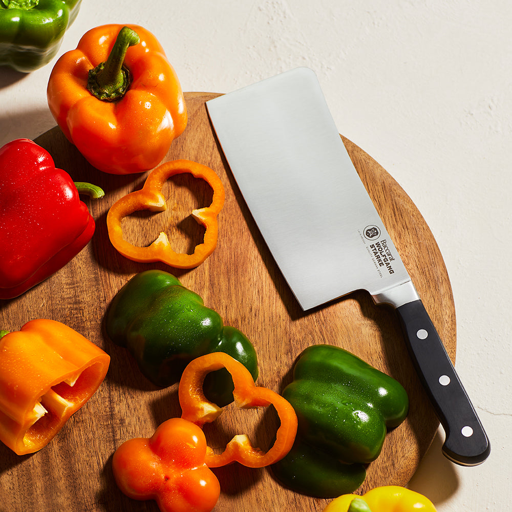 A sharp cleaver with a black handle on a white background stainless steel kitchen knife - Baccarat