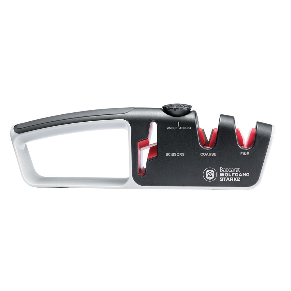 Person sharpening a knife with a black and red santoku knife 18cm - Baccarat wolfgang starke