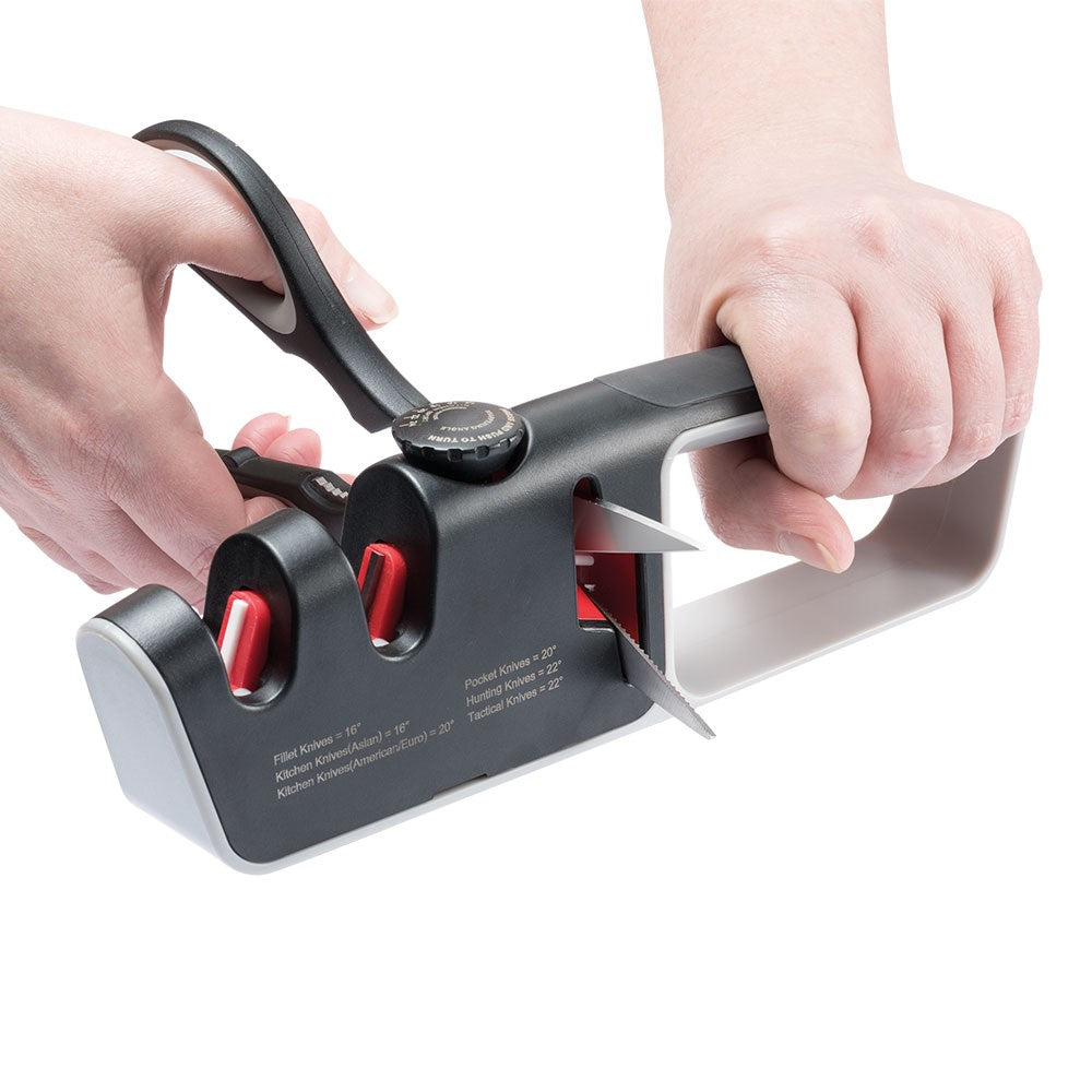 Person sharpening a knife with a black and red santoku knife 18cm - Baccarat wolfgang starke