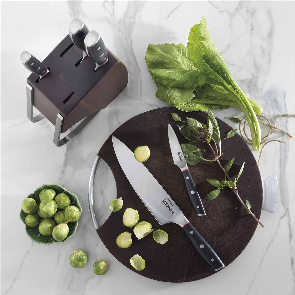 Three stainless steel knives on a dark wood countertop cookware set with egg poacher - Iconix Holz
