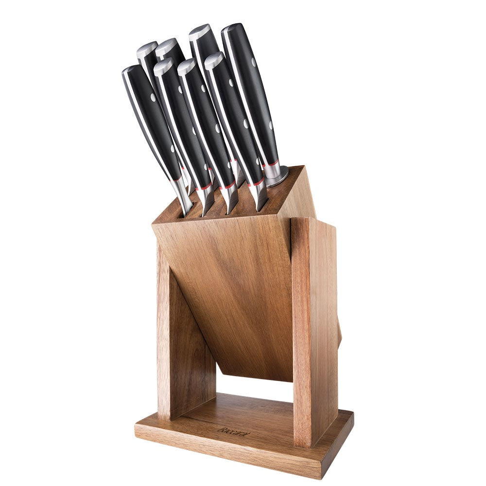 Wooden knife block with 9-piece black-handled knives on marble with herbs on cutting board- Baccarat