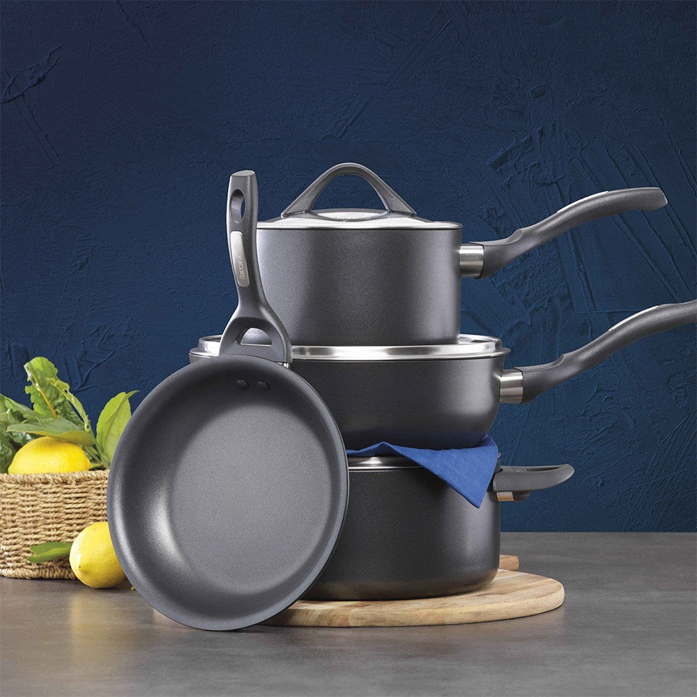 Modern kitchen with pans cutting boards and colourful peppers black cookware knife block - Baccarat