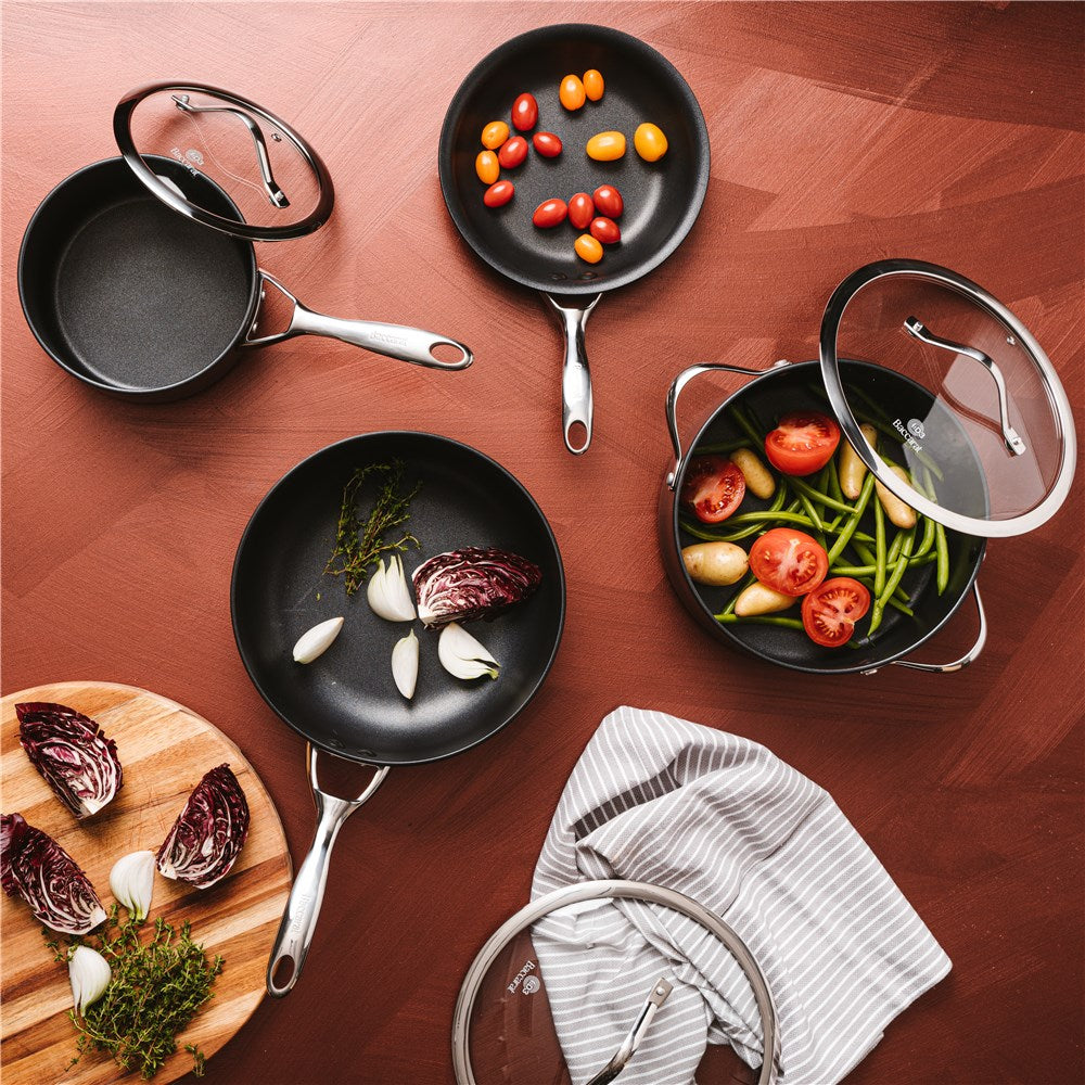 Stacked black cookware cutting boards and colourful peppers 4 piece cookware set - ID3 CS Ultimate