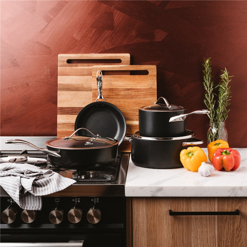 Stacked black cookware cutting boards and colourful peppers 4 piece cookware set - ID3 CS Ultimate