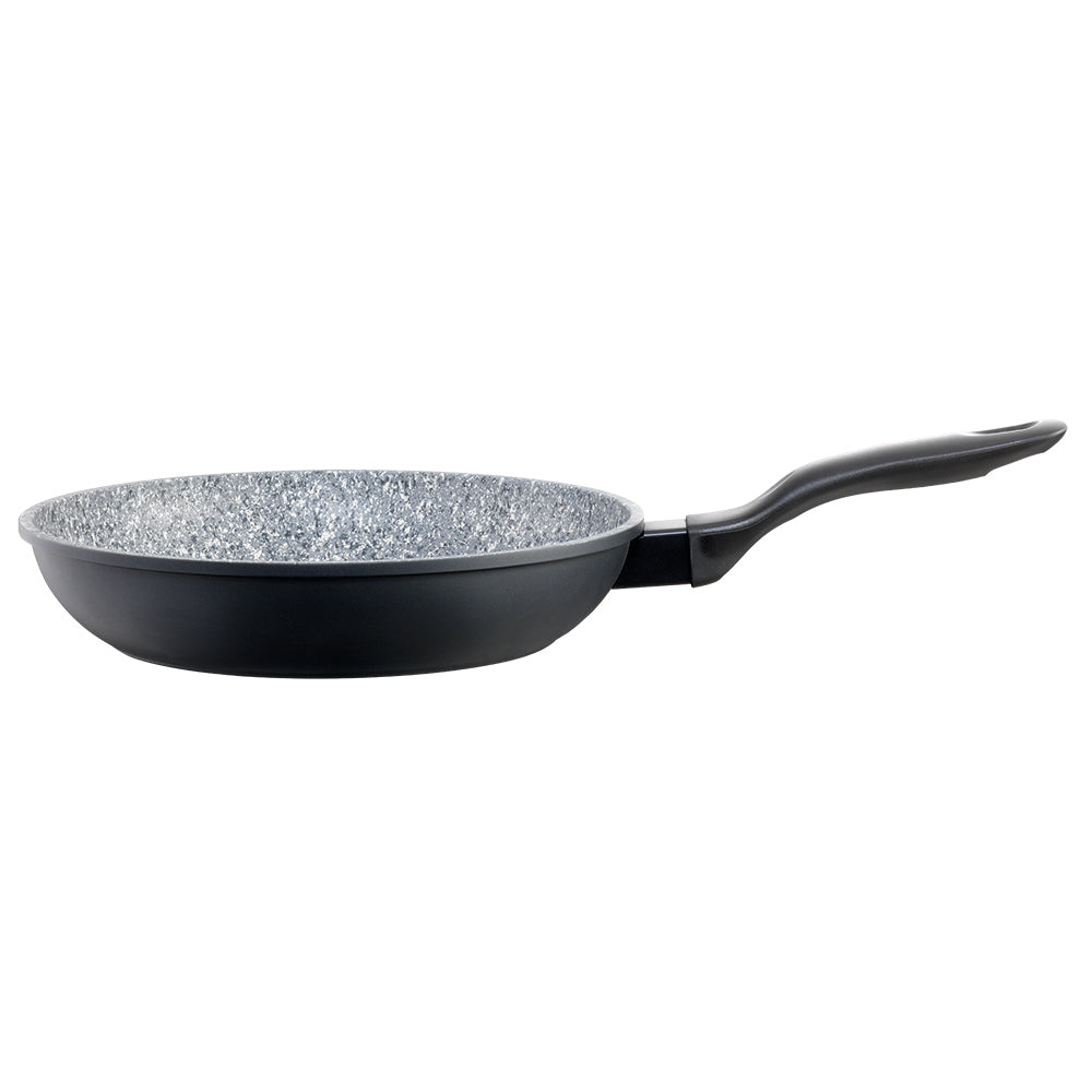 A black frying pan with green peas onions and broccoli on a wooden board 28cm frypan - Baccarat